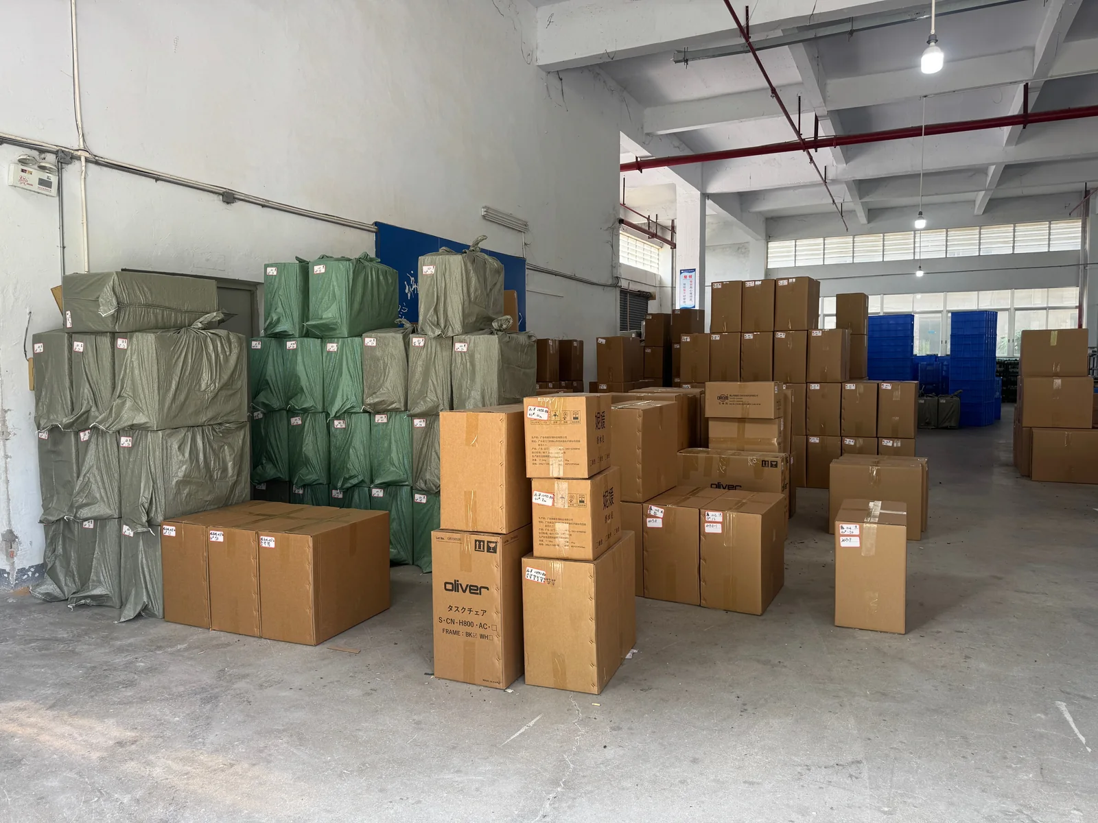 Cartons and wrapped finished products in the factory warehouse.