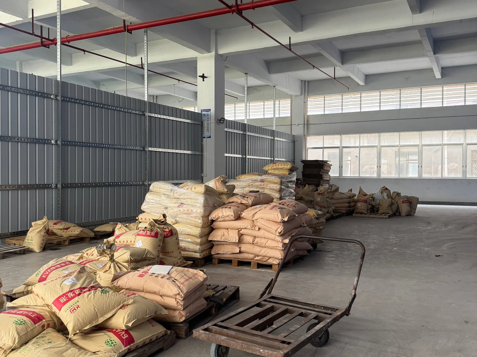 Bagged production materials arranged in the factory storage area.
