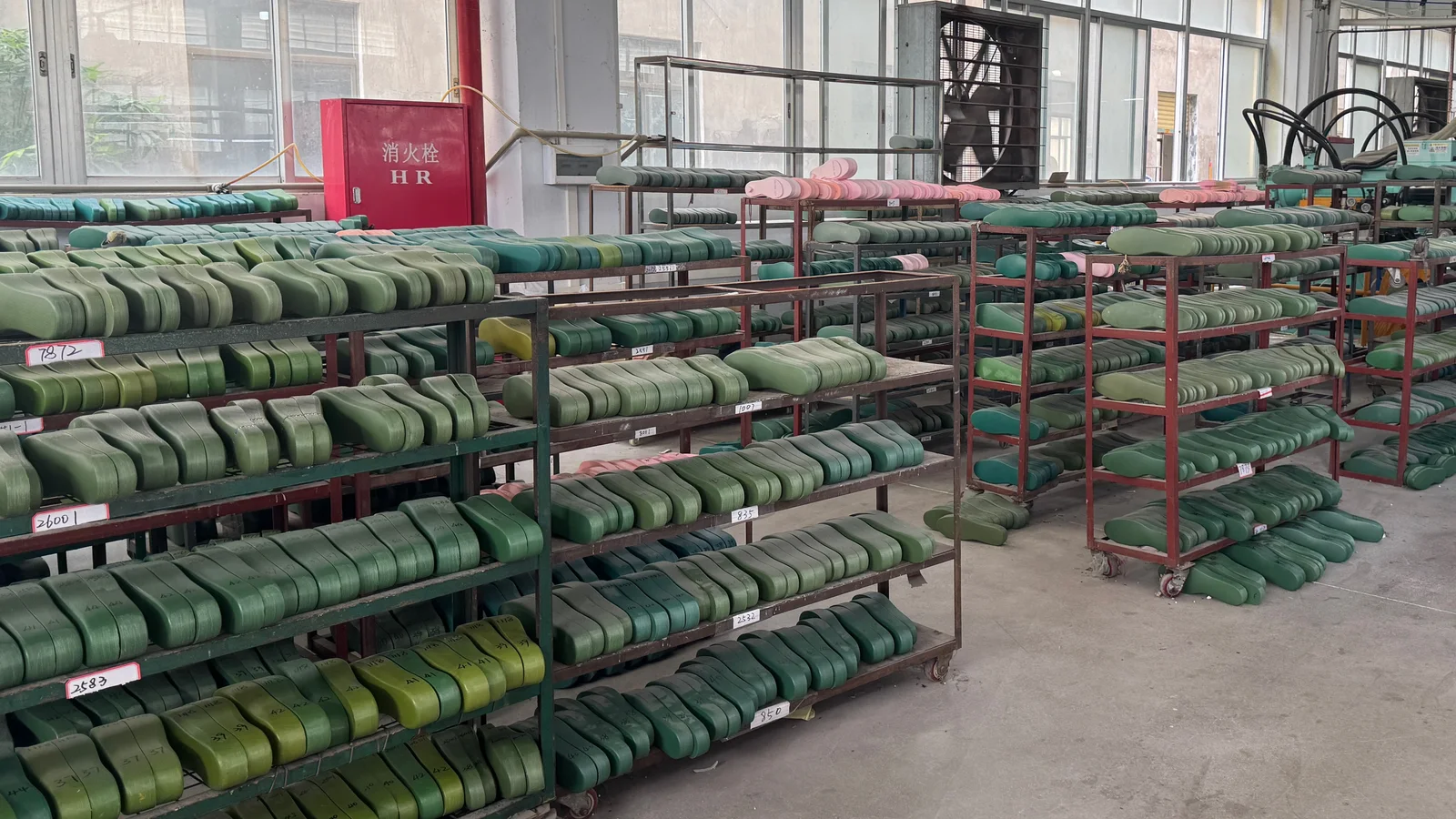 Sole shaping forms arranged on workshop racks.